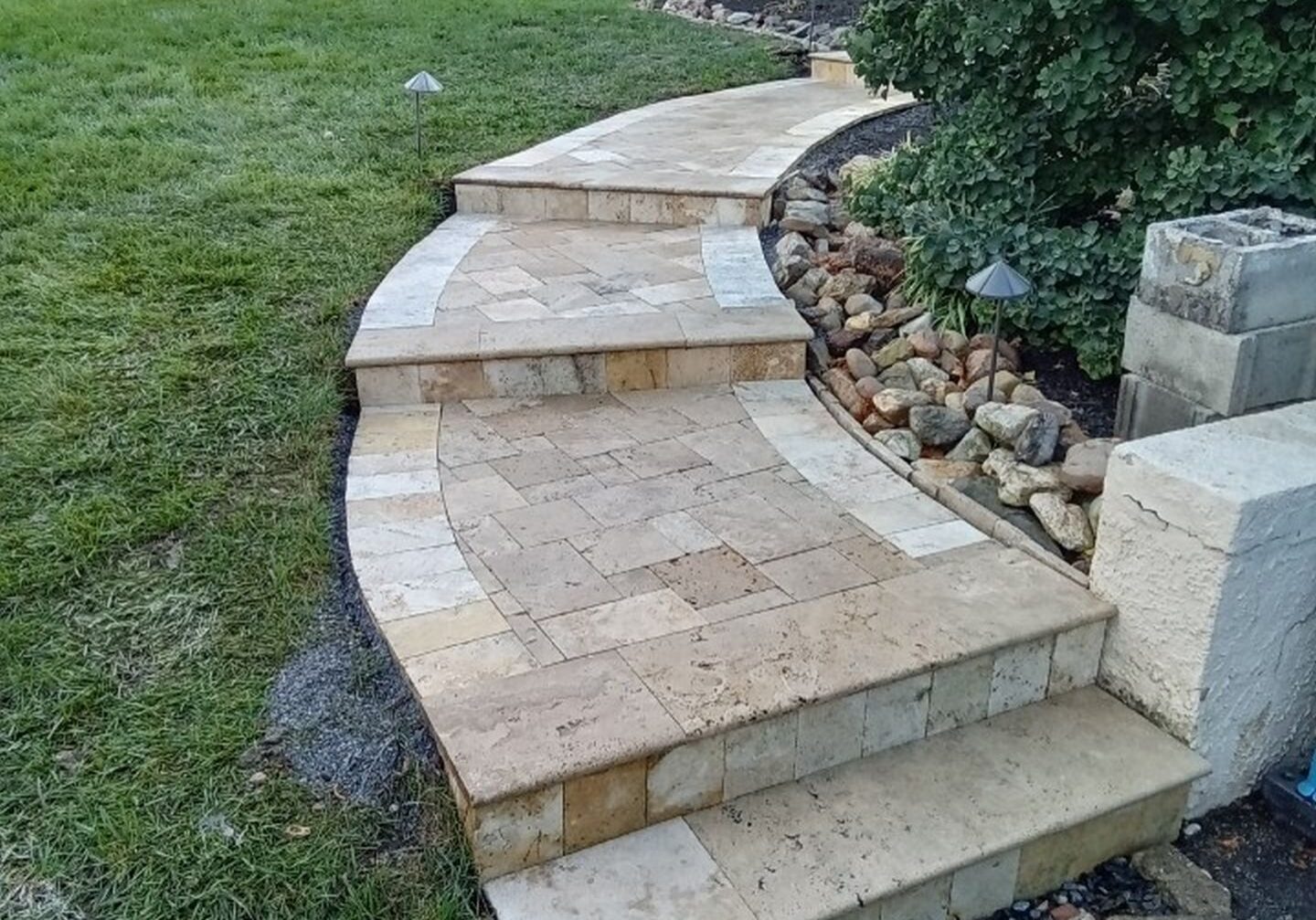 Beautiful travertine steps and a curved stone walkway installed for a residential property in Newark, DE.