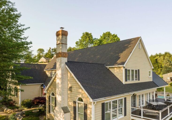 Asphalt shingle roof with seam metal roofing on the porch