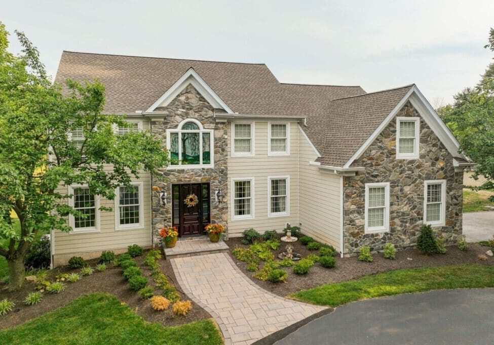 Home tranformation with stucco remediation, new siding and stone work, new deck and covered porch.